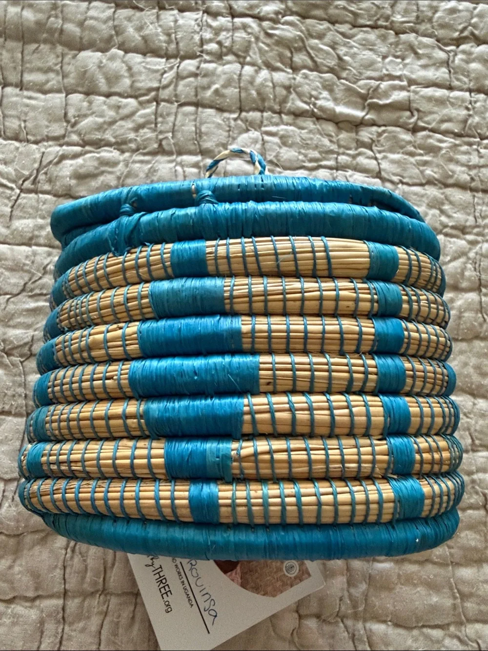 Handmade turquoise and tan coveted basket from Uganda clasp in the front